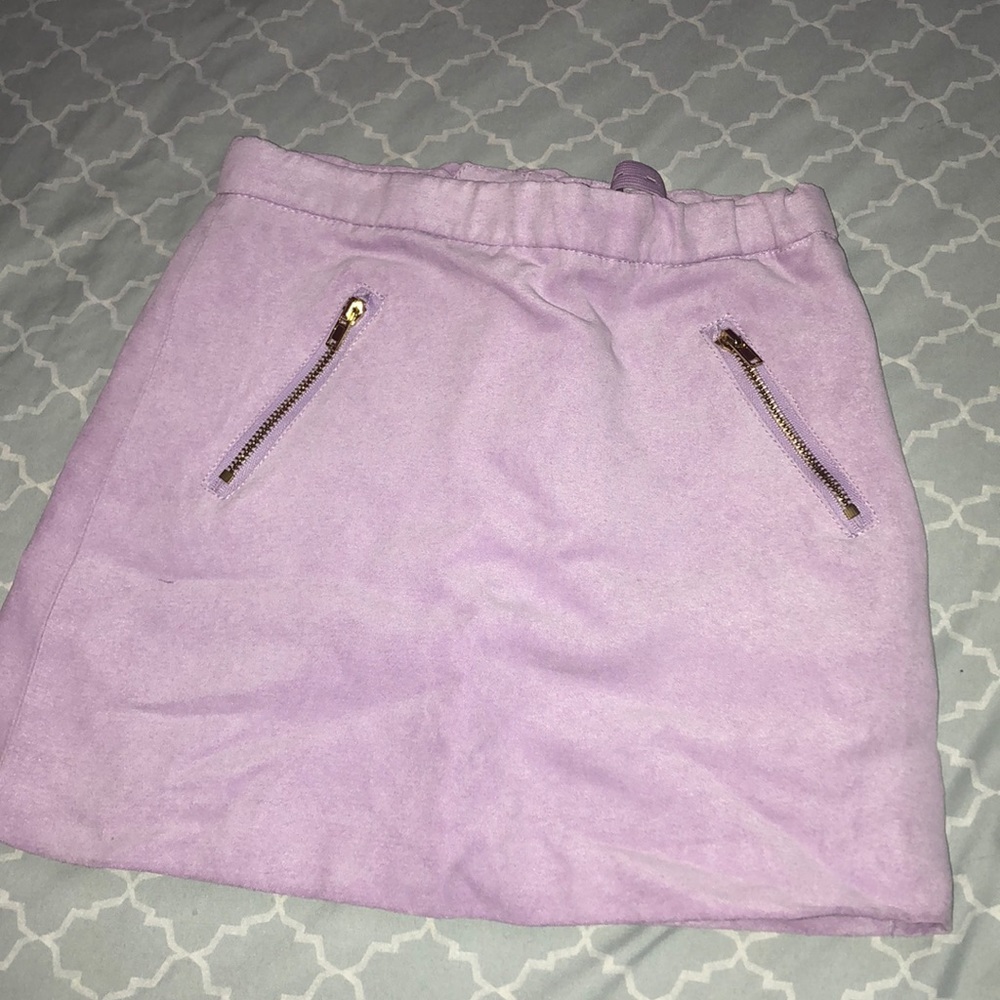 A purple skirt with a bow on the zipper